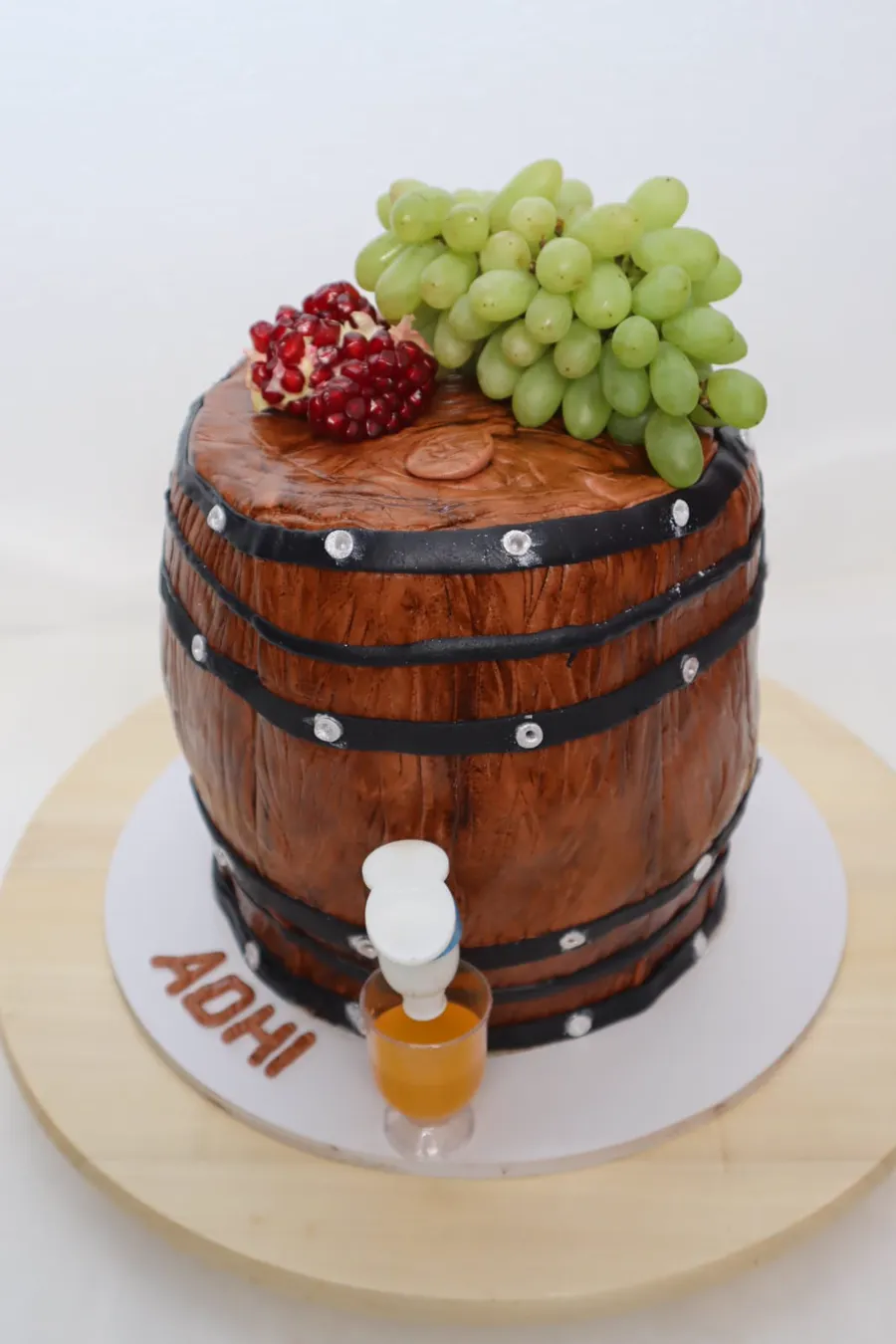 Wine barrel sculpted cake topped with grapes