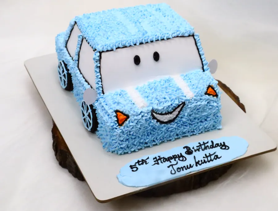 Blue cartoon car cake piped in buttercream