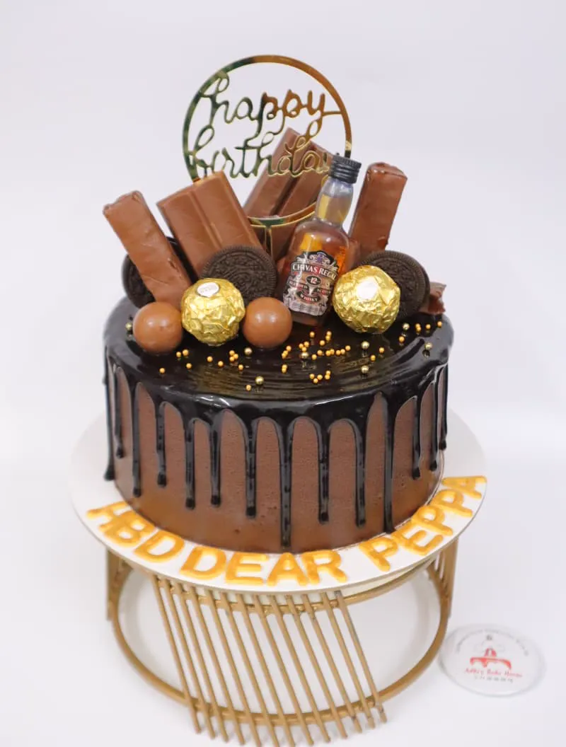 Chocolate drip cake loaded with chocolates on a gold stand