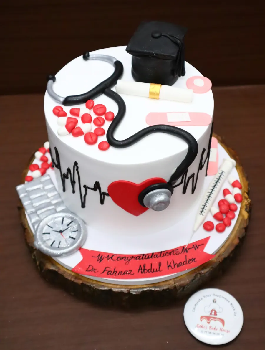 Graduation cake with a stethoscope, cap and heartbeat line
