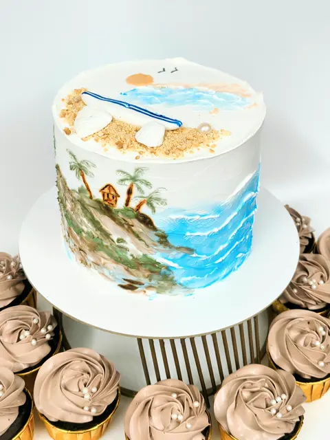 Hand-painted beach theme cake with cupcakes