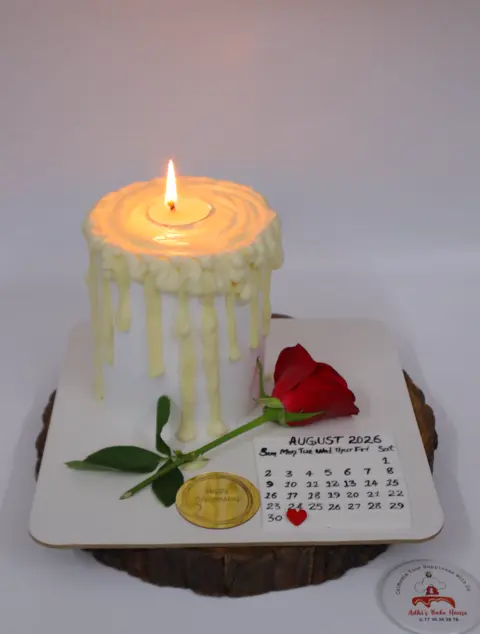Cake shaped like a dripping candle with a calendar board and a red rose