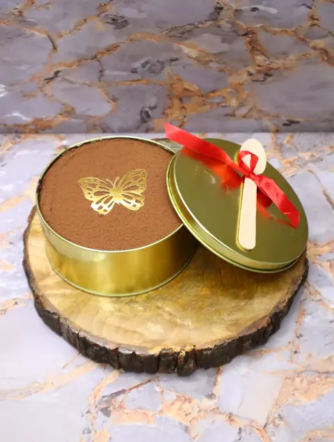 Tiramisu in a gold gift tin with a butterfly topper