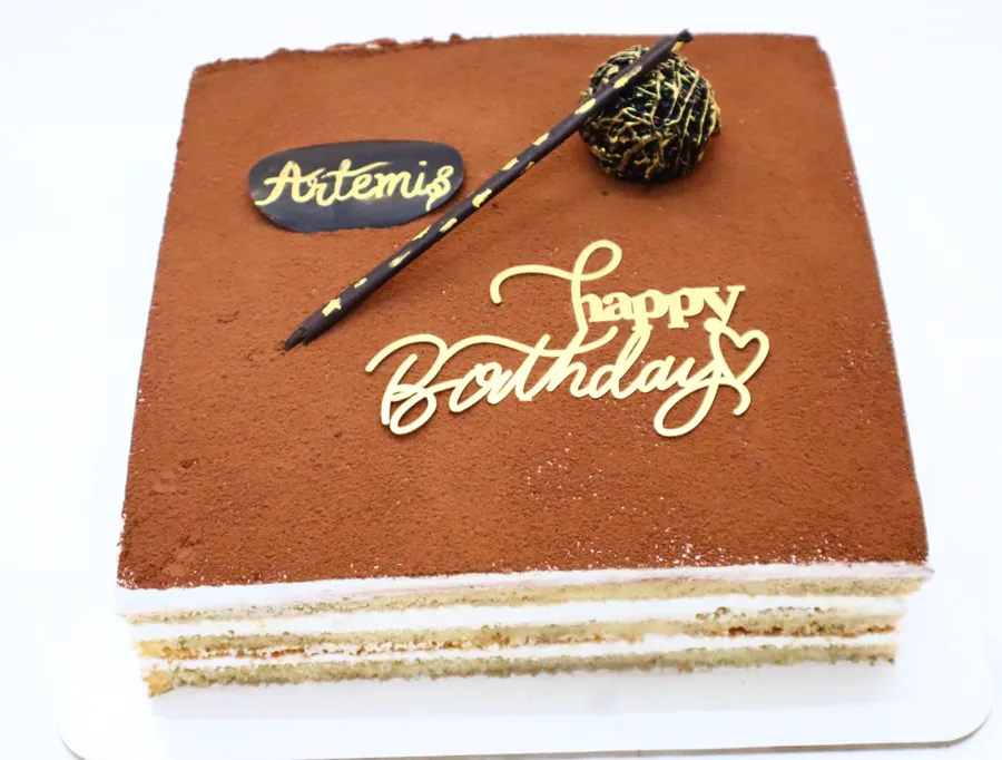 Layered tiramisu with a gold Happy Birthday topper